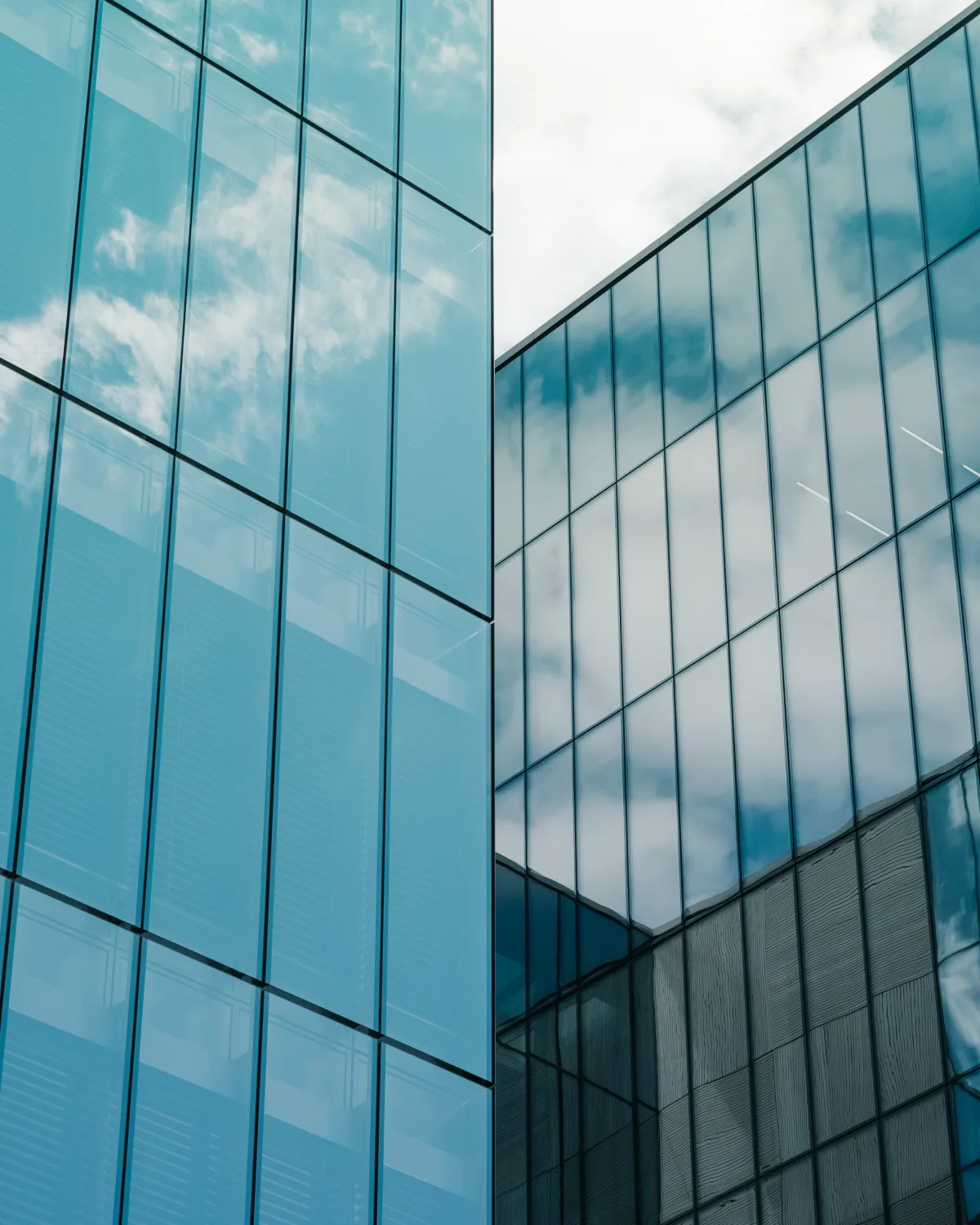 Modern blue glass office buildings reflecting the sky